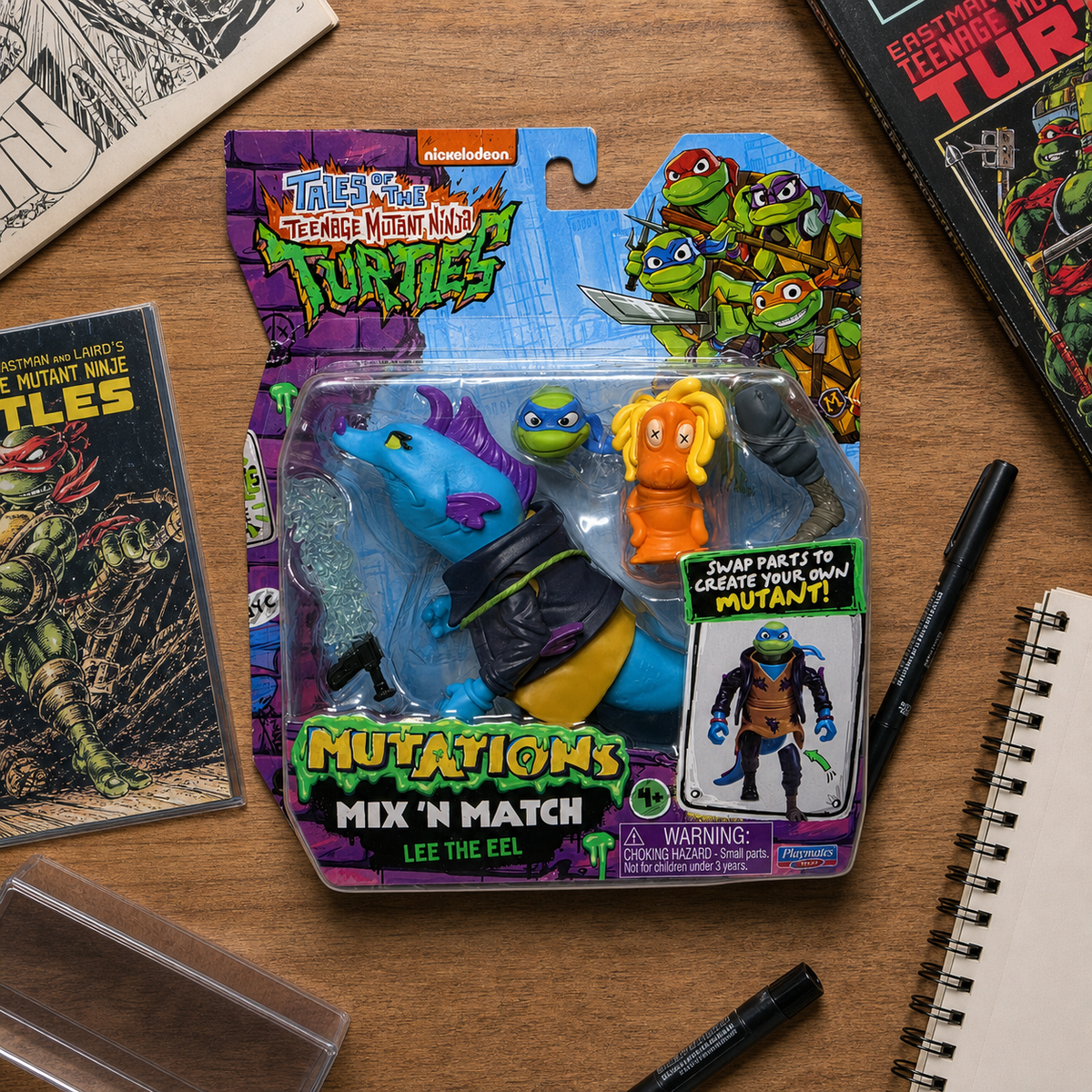 Illustrative lifestyle image of TMNT Mutations Mix N Match Lee the Eel package on a collector desk
