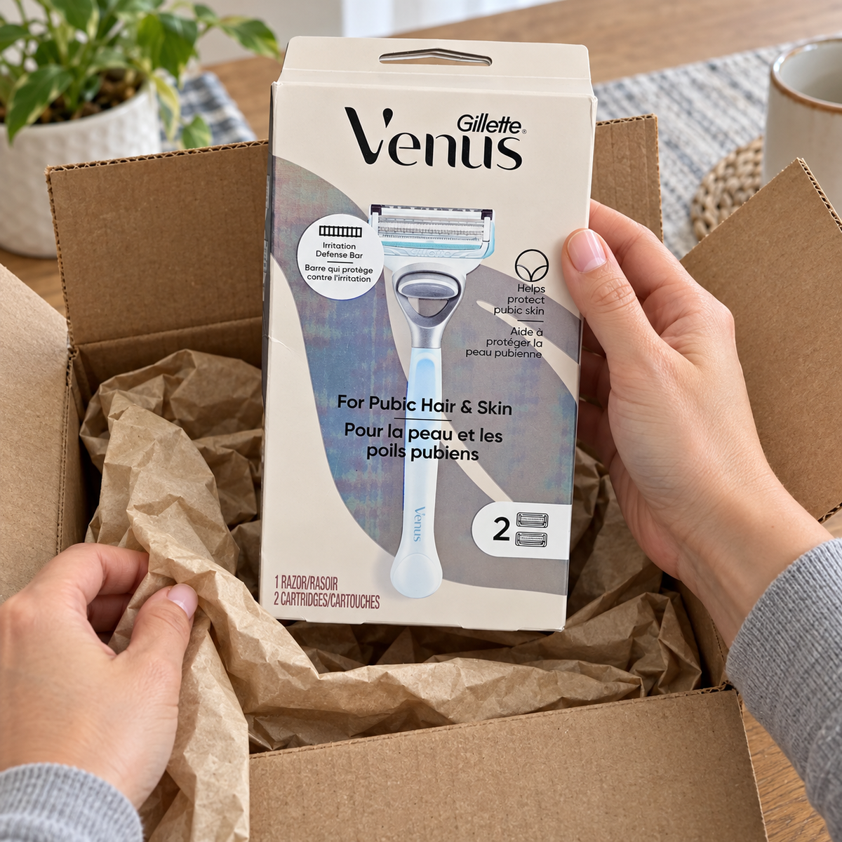 Adult hands unpack a closed Gillette Venus For Pubic Hair & Skin carton labeled one razor and two cartridges.