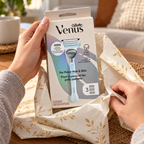 Adult hands unwrap a closed Gillette Venus For Pubic Hair & Skin carton labeled one razor and three cartridges.