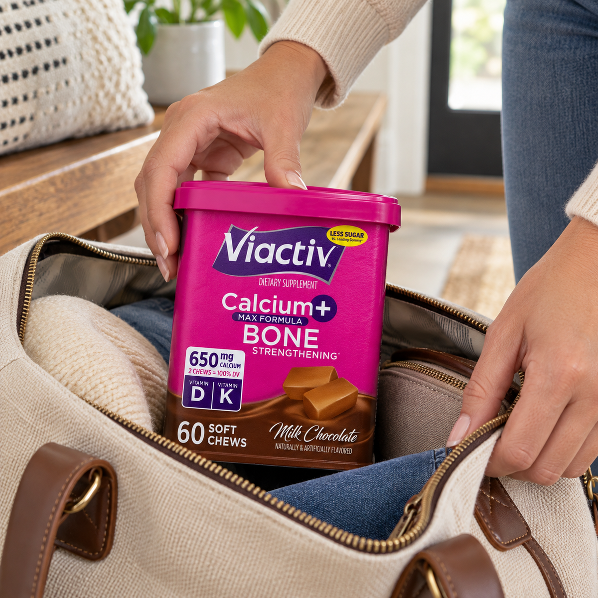 Hands packing a closed Viactiv Milk Chocolate 60-chew container in a weekend bag.