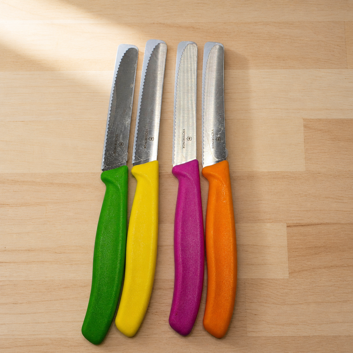 Victorinox four-piece colorful serrated knife set styled product image