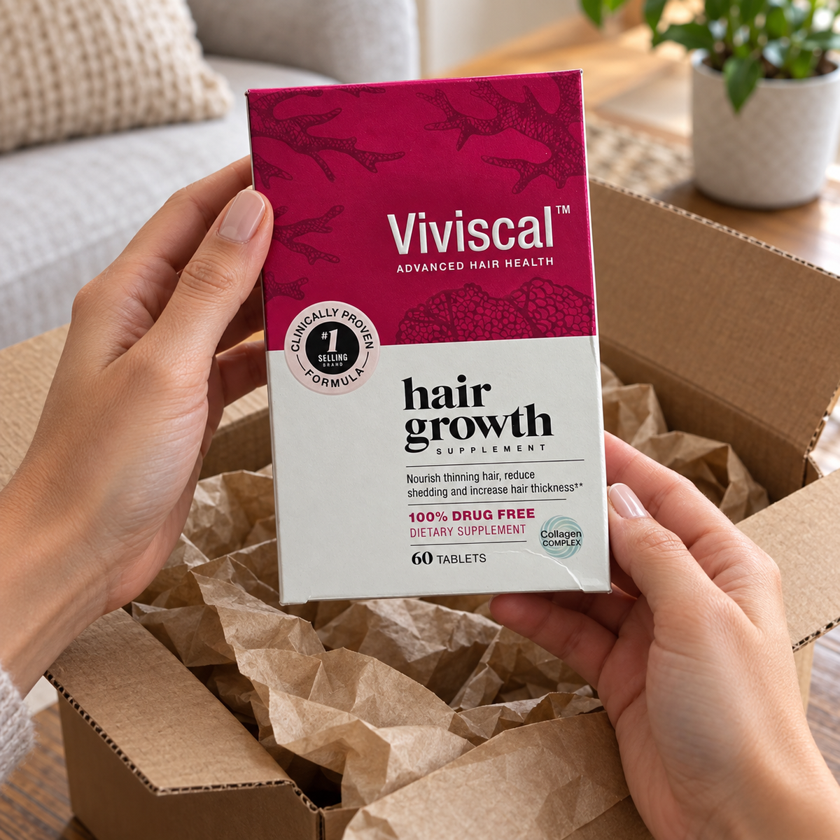 Adult hands unpacking the 60-tablet Viviscal carton