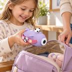 Child placing a lavender Panda Kidzcam camcorder into an everyday day bag.