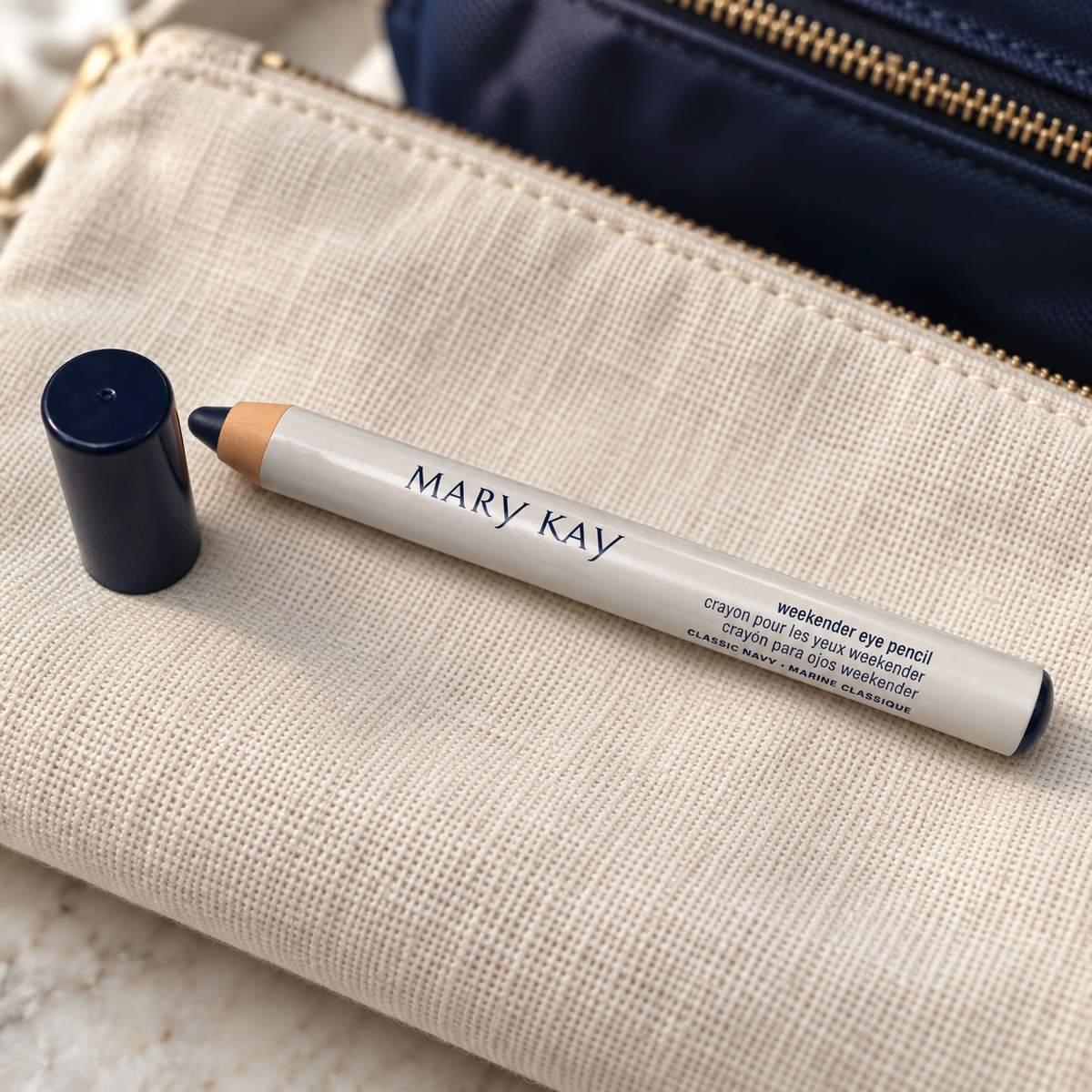 Mary Kay Weekender Classic Navy eye pencil and cap on a cream travel pouch