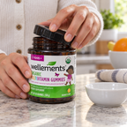 Adult opening a Wellements Organic Multivitamin Gummies bottle