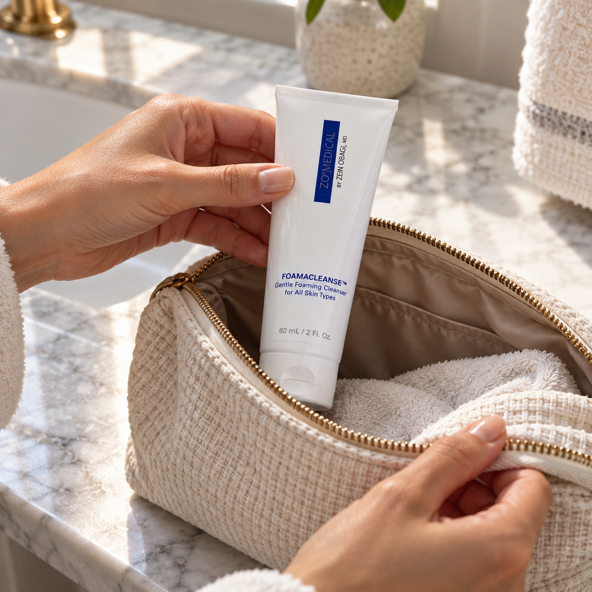 AI-staged scene: Adult packing ZO Medical Foamacleanse 60 mL into a wash bag; props not included.