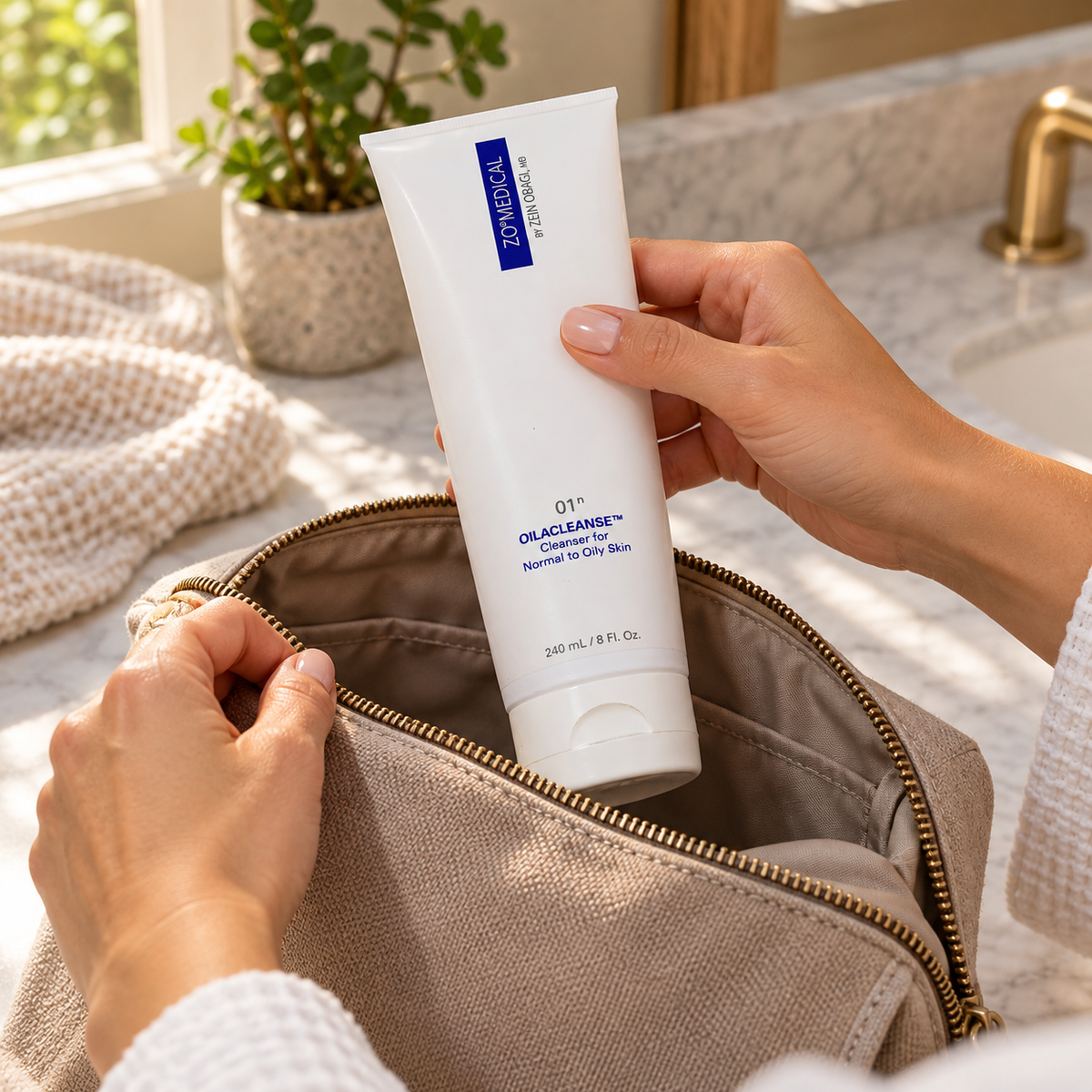 Adult packing ZO Medical Oilacleanse 240 mL into a wash bag