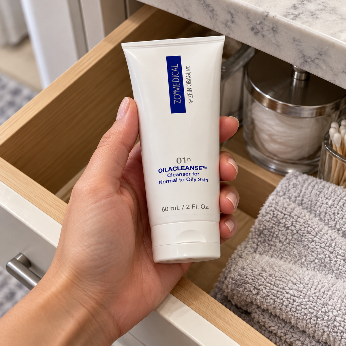 Adult taking ZO Medical Oilacleanse 60 mL from a bathroom drawer