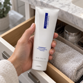 Adult taking ZO Medical Vitascrub 116 g from a bathroom drawer