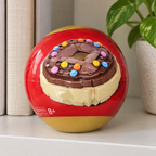 AI-generated lifestyle illustration of one closed ZURU MAX Premium Snacks donut capsule on a collector shelf. Props not included.